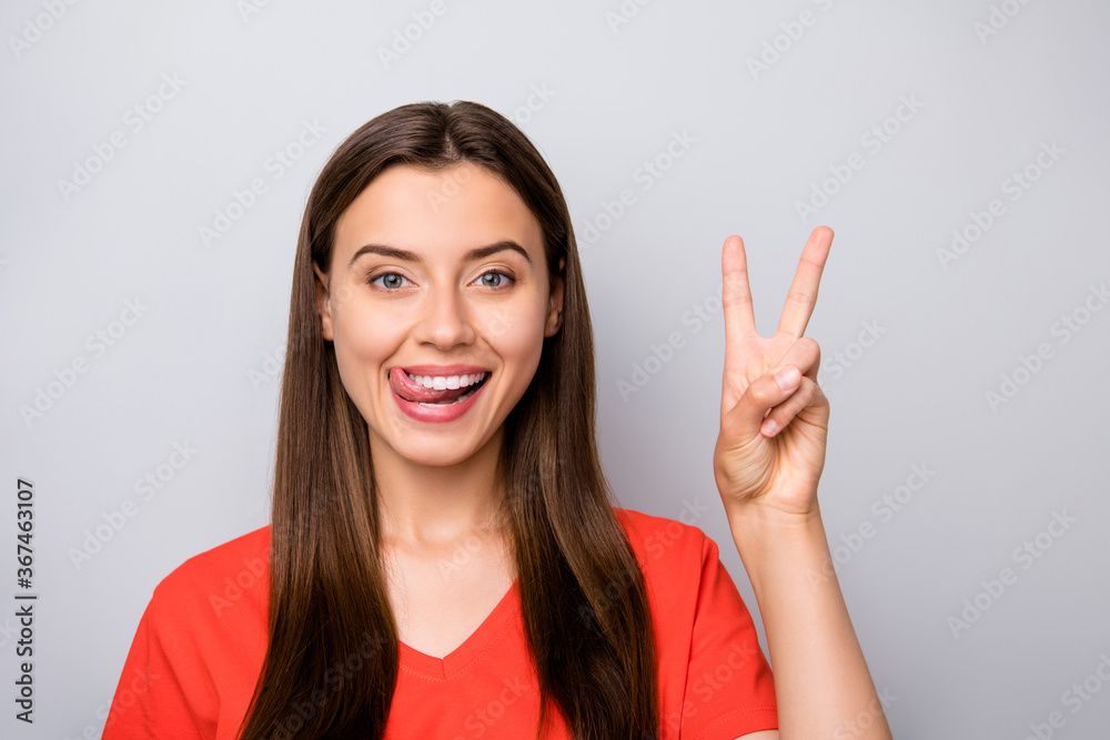 Close-up portrait of her she nice attractive lovely cute winsome funky cheerful cheery straight-haired girl showing v-sign licking lip having fun isolated over light gray pastel color background Close-up portrait of her she nice attractive lovely cute winsome funky cheerful cheery straight-haired girl showing v-sign licking lip having fun isolated over light gray pastel color background