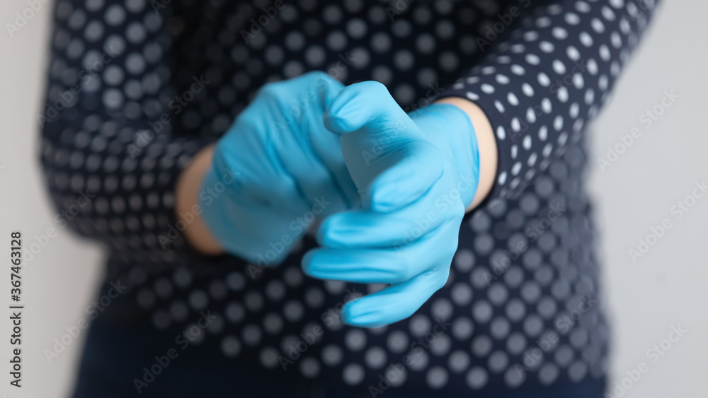Crop close up of woman wear medical protective rubber gloves against corona virus pandemics, female try put protecting hands gear save from covid-19 coronavirus epidemics, healthcare concept