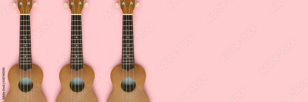 Banner with ukulele on a pink pastel background. Creative header with place for text.