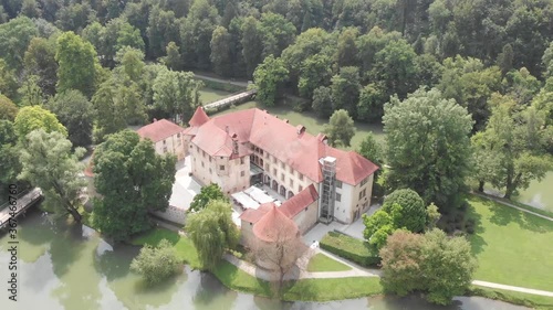 Drone view of a castle Otočec with two bridges on each side of the island. Beautiful Otocec castle from the air. Slovenian fortress surrounded by a river near Novo Mesto. photo