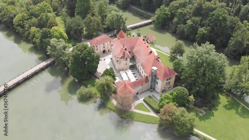 Aerial shot of Castle Otočec. Review of a five star hotel and restaurant in Otocec, Slovenia. Beautiful Otocec castle in the nature forest near river in Slovenia. photo