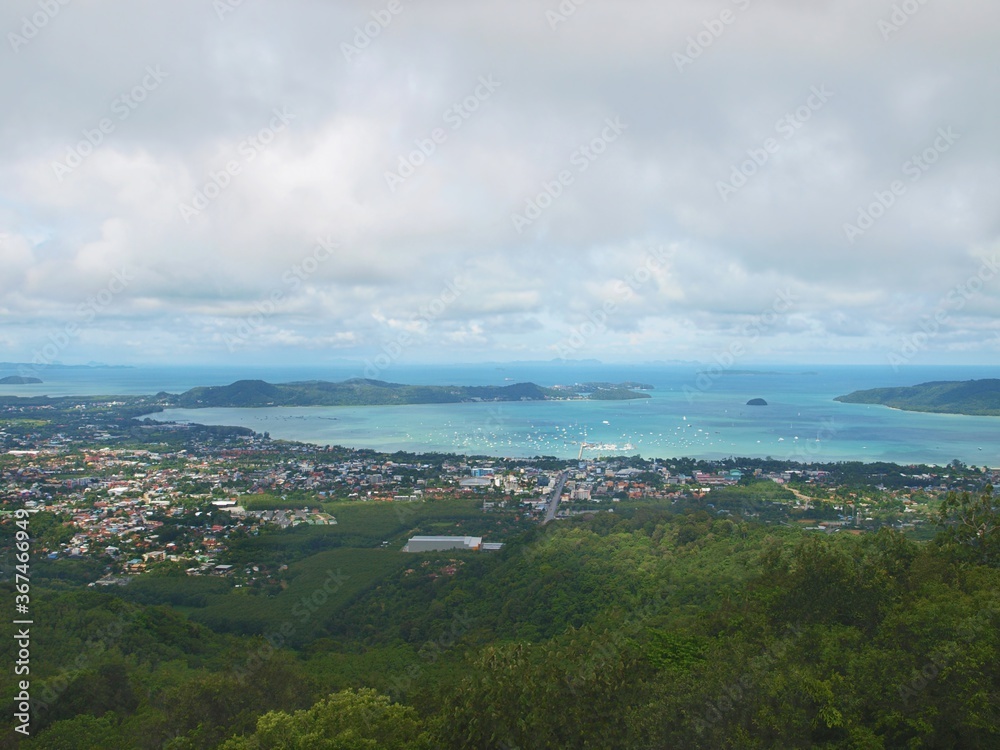 Panoramic image from Big Buddha Phuket view point on the tip of hill to the Chalong sea bay. Sea and boats. Blue water, pier. Resort of Thailand. Tropical paradise. Harbor, anchored yachts and ships