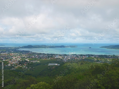Panoramic image from Big Buddha Phuket view point on the tip of hill to the Chalong sea bay. Sea and boats. Blue water, pier. Resort of Thailand. Tropical paradise. Harbor, anchored yachts and ships © Oxana
