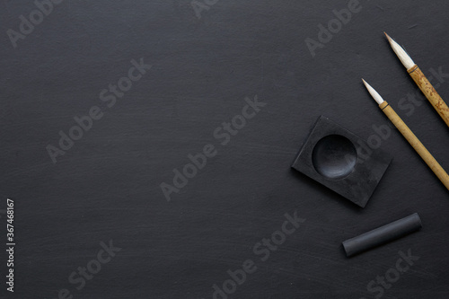 closeup Japan traditional writing brush on black table. top view. flat lay photo