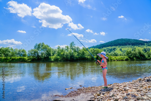 Little beautiful girl is fishing. Summer vacation, healthy lifestyle and sport concept.