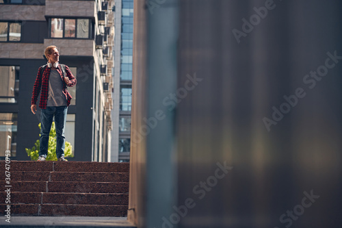 Cheerful stylish man standing on street stairs © Viacheslav Yakobchuk