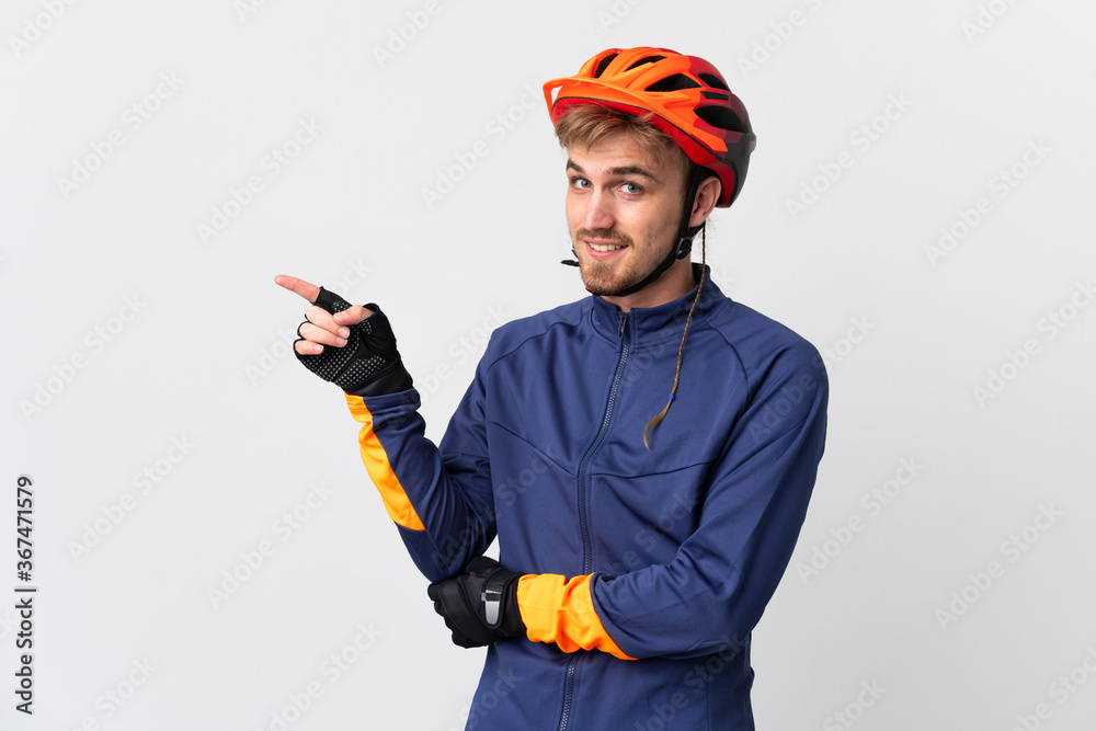Young cyclist blonde man isolated on white background pointing finger to the side Young cyclist blonde man isolated on white background pointing finger to the side
