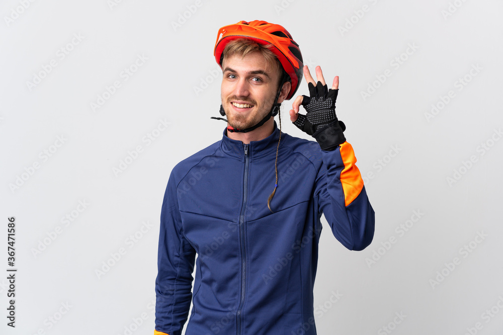 Young cyclist blonde man isolated on white background showing ok sign with fingers Young cyclist blonde man isolated on white background showing ok sign with fingers