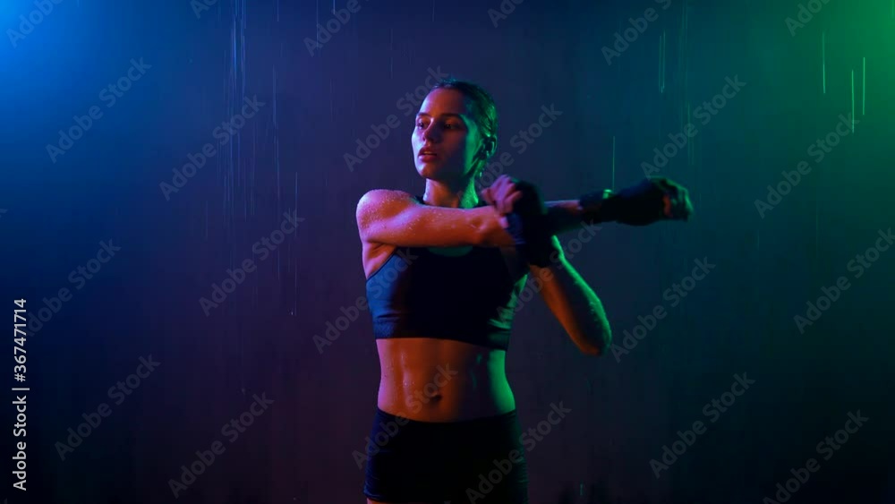Female boxer warming up, rain. Female boxer warming up, rain.
