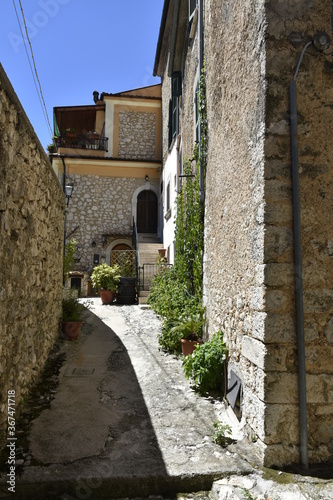 Fototapeta Naklejka Na Ścianę i Meble -  A narrow street in the old buildings of San Donato Val di Comino, a medieval village in the Lazio region.