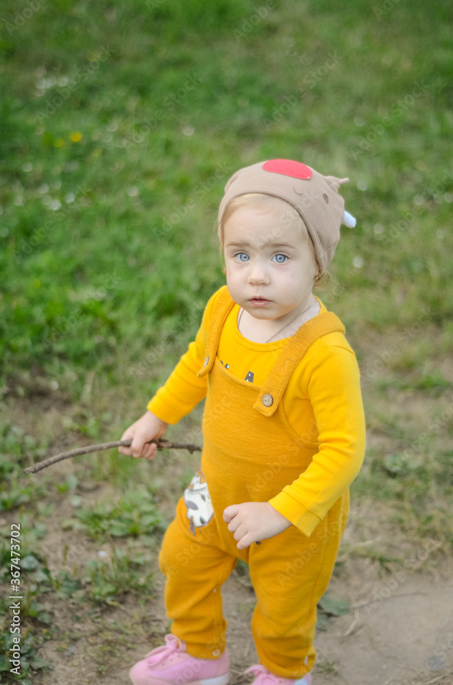 Photo of a blue-eyed toddler girl playing outside on the playground Photo of a blue-eyed toddler girl playing outside on the playground