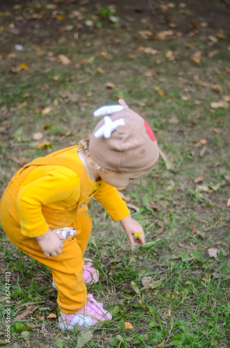 Photo of a blue-eyed toddler girl playing outside on the playground