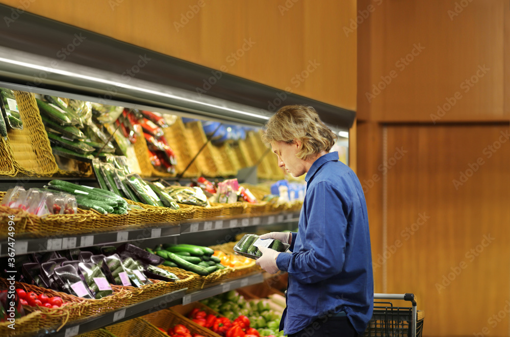 Supermarket shopping,  gloves,man buying vegetables at the market	