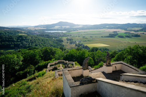 Hill and chapels Kalvarie - Ostre. Pilgrimage place in mountains. View of the Czech landscape at sunset. Golden watch photo