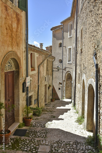 Fototapeta Naklejka Na Ścianę i Meble -  A narrow street in the old buildings of San Donato Val di Comino, a medieval village in the Lazio region.