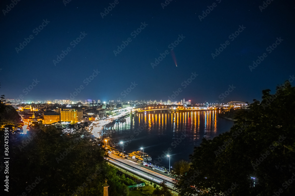 Comet C/2020 F3 (NEOWISE) at night over the city. Kyiv. Dnieper River. Ukraine.