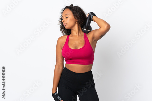 Teenager cuban girl isolated on white background making weightlifting with kettlebell