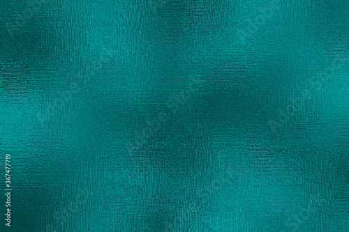 Turquoise metallic effect. Texture shine foil. Background with glitterer metal effect. Blue green surface. Backdrop glitter mint metal plate. Metallic texture foil for design invitation, cards, prints