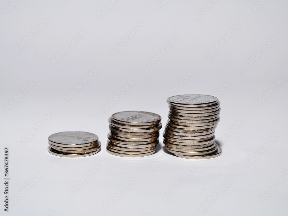 Pile of Rupiah coins isolated on white background. Indonesian currency. investment, business and saving money concept Pile of Rupiah coins isolated on white background. Indonesian currency. investment, business and saving money concept