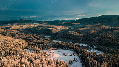 Carpathian mountains winter. Snow coniferous forest at sunset.