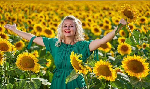 Young attractive woman in a sunflower field