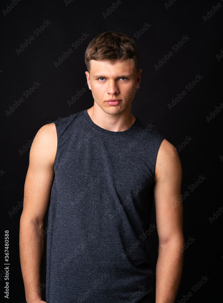 Portrait of young man over isolated black background Portrait of young man over isolated black background