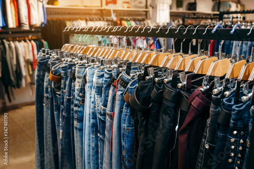 Row of hanged blue and black jeans in a shop