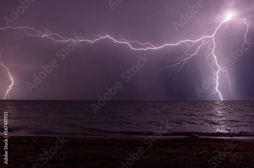 night shooting of a thunderstorm over the sea, photography of lightning