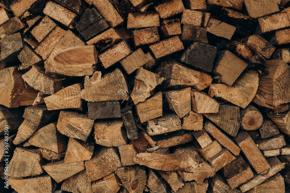 Background of dry chopped firewood logs in a pile