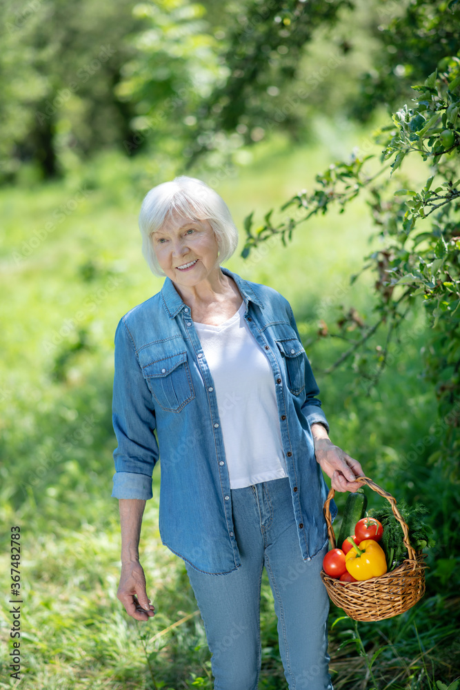 Woman gathering vegetables from the kitchen garden Woman gathering vegetables from the kitchen garden