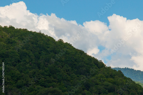 white clouds over the mountains as a landscape © studybos