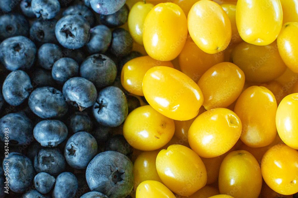 Mix of yellow and blue berries. Summer mick fruit. Berry layout Mix of yellow and blue berries. Summer mick fruit. Berry layout