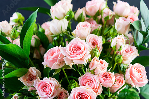 Bouquet of several branches of pink roses. Background of pink roses