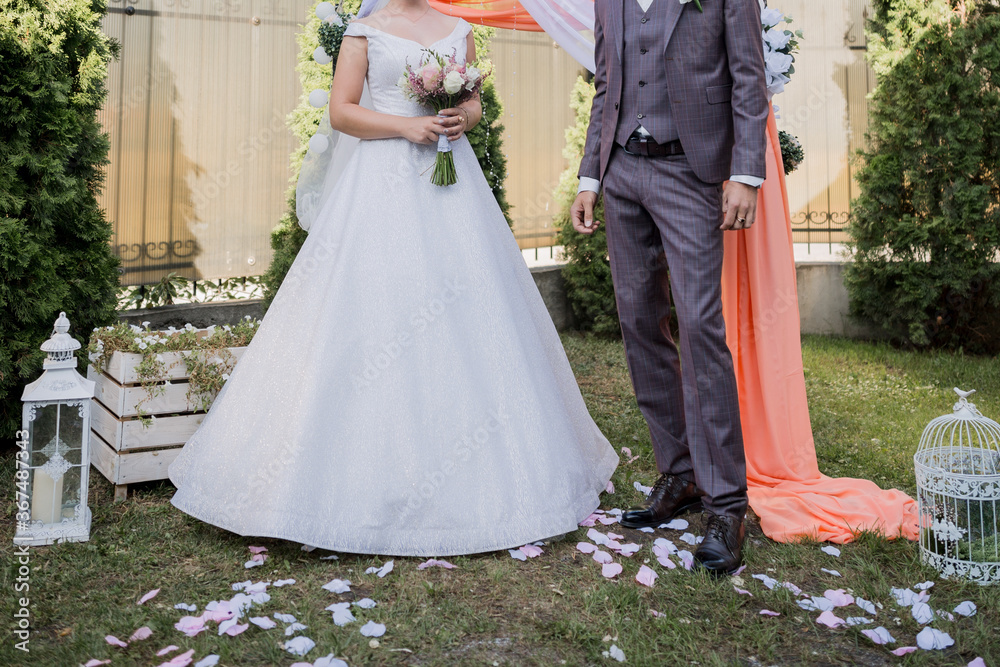 groom with bride near arch for wedding ceremony groom with bride near arch for wedding ceremony