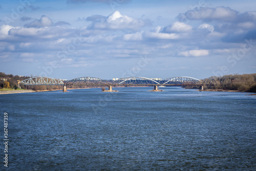 Distance view of railway bridge over River Vistula in Torun city, Poland photo