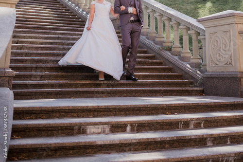 groom with bride on stairs near the building
