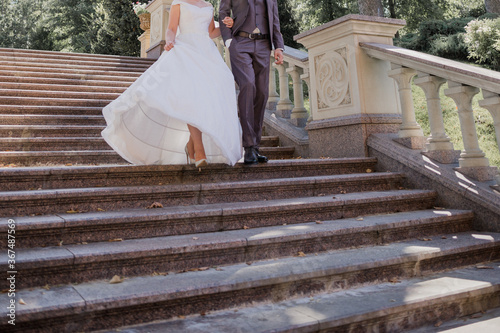 groom with bride on stairs near the building