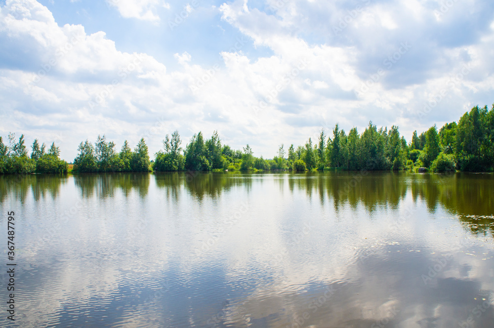 Fototapeta premium Summer lake shore with sky reflection