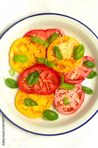 salad of red and yellow tomatoes and basil 