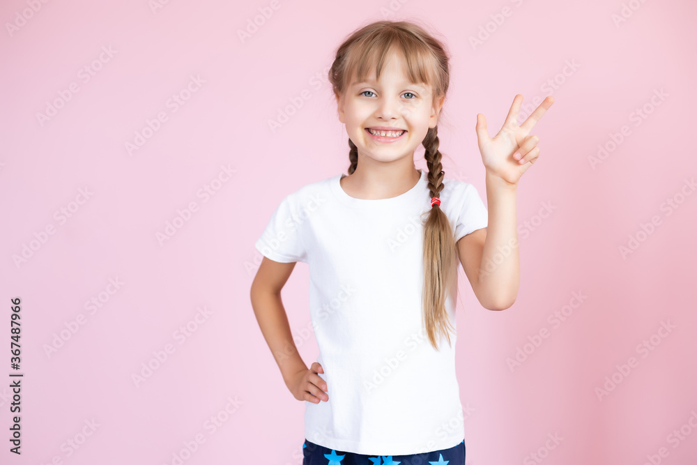 Beautiful little blonde girl with long hair in white T-shirt smiling on a pink background Beautiful little blonde girl with long hair in white T-shirt smiling on a pink background