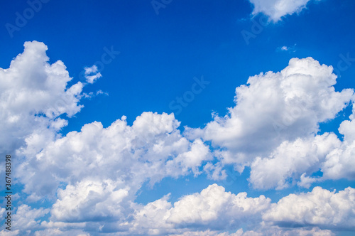 White bright contrasting clouds on blue sky