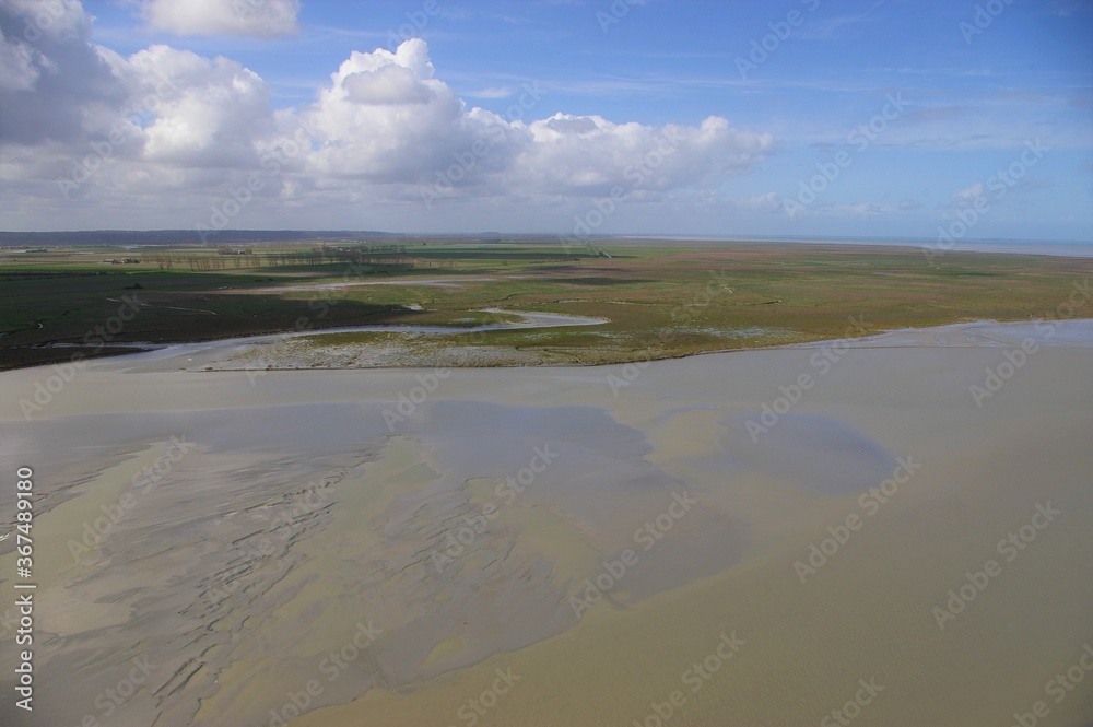 A view of a flat coastal landscape in Normandy, France. A view of a flat coastal landscape in Normandy, France.