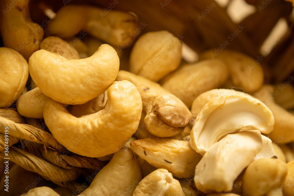 Cashew nuts scattered surface texture. Close up.