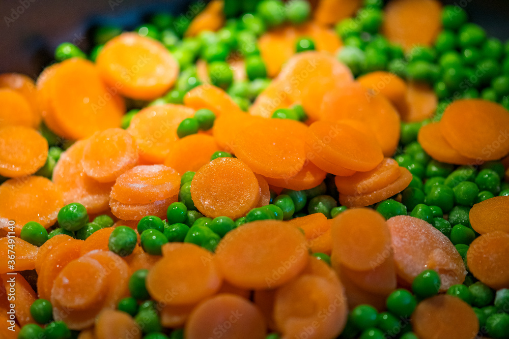 fast cooking peas with carrot slices in the pan fast cooking peas with carrot slices in the pan
