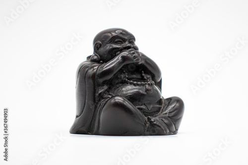 Statue speak no evil, Black sculpture rock on white, Isolated, Front angle.
