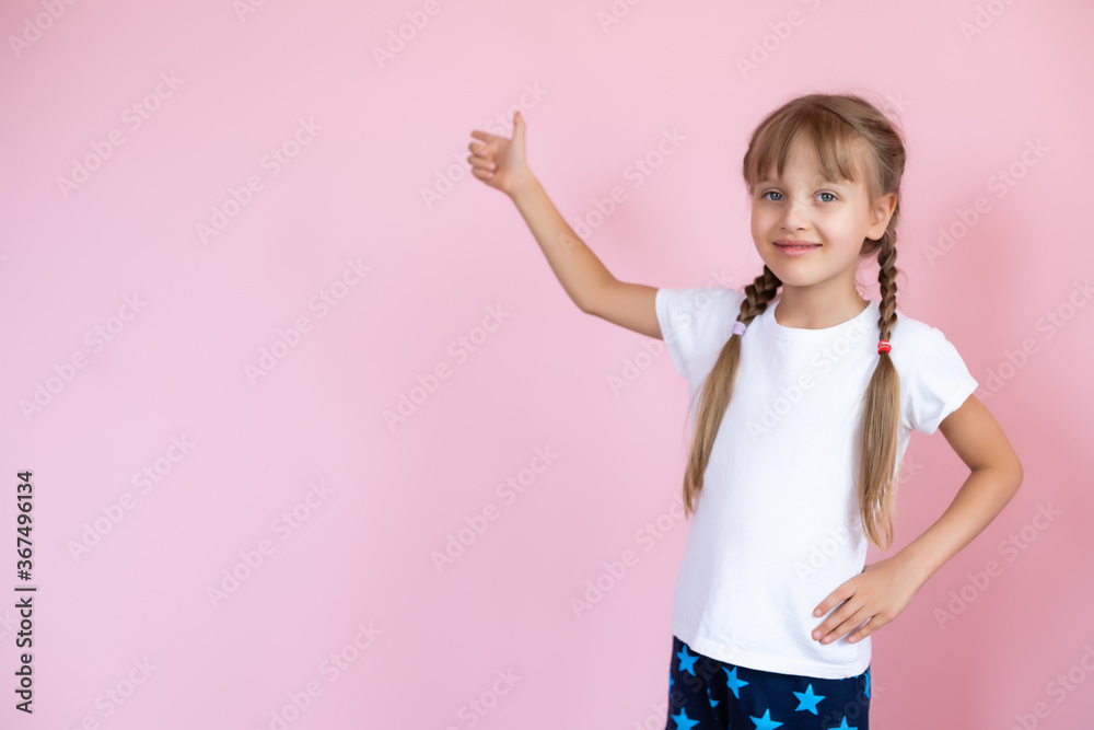 Beautiful little blonde girl with long hair in white T-shirt smiling on a pink background Beautiful little blonde girl with long hair in white T-shirt smiling on a pink background