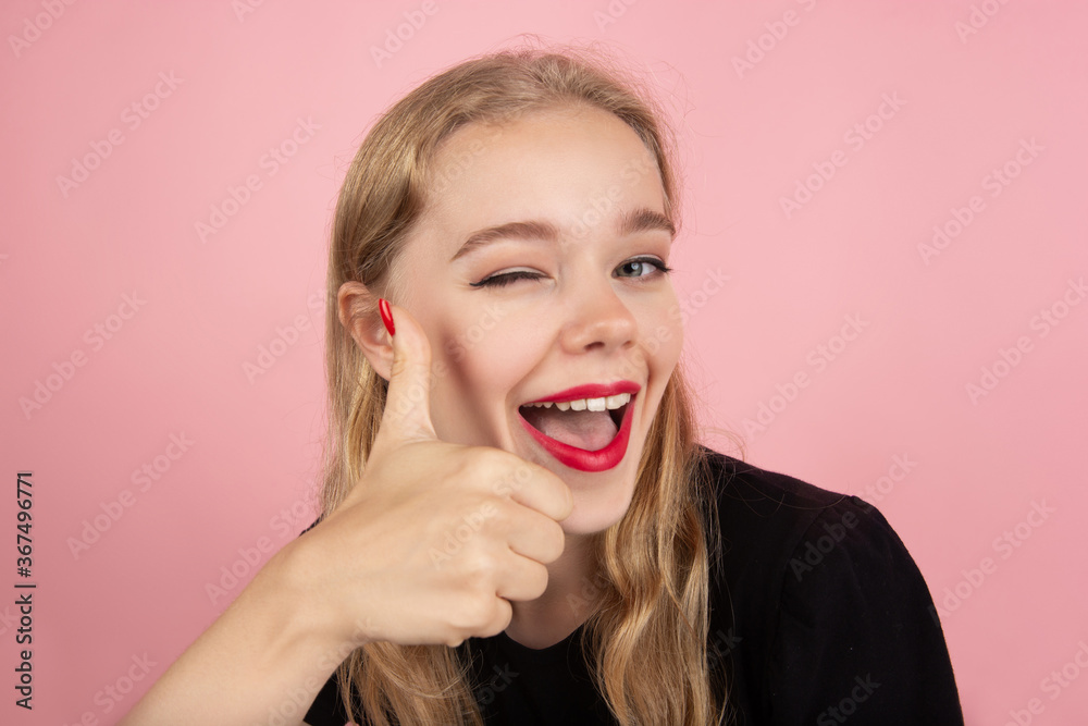 Thumbs up. Portrait of young emotional woman gesturing isolated on pink studio background. Human emotions, facial expression, sales, ad concept. Blonde caucasian pretty model gesturing. Copyspace. Thumbs up. Portrait of young emotional woman gesturing isolated on pink studio background. Human emotions, facial expression, sales, ad concept. Blonde caucasian pretty model gesturing. Copyspace.