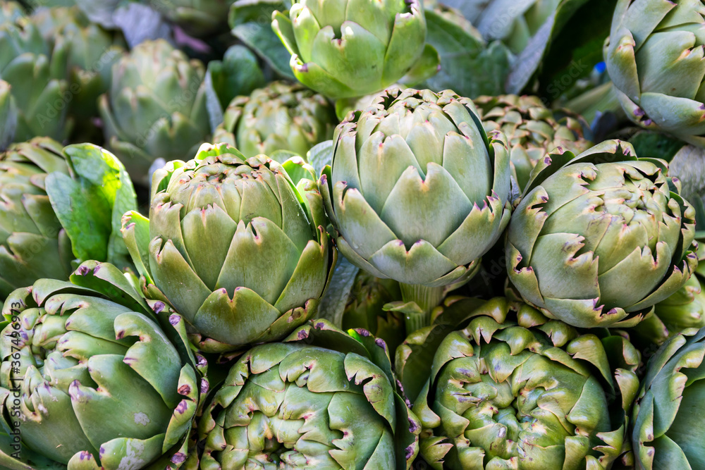 Fresh and organic artichokes on market stall. Fresh and organic artichokes on market stall.