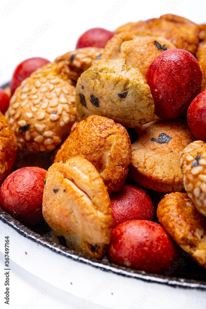Tasty asian vegetarian appetizer, crunchy rice en peanuts snacks from Japan close up on white backgound Tasty asian vegetarian appetizer, crunchy rice en peanuts snacks from Japan close up on white backgound
