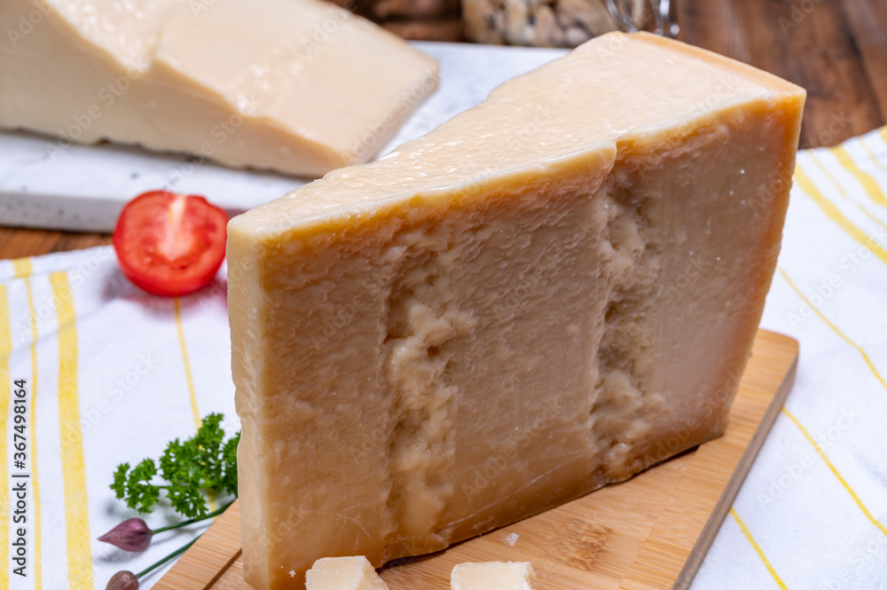 Big wedges of parmigiano-reggiano parmesan hard Italian cheese made from cow milk or Grana Padano